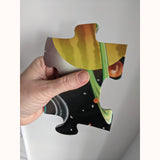 Solar system M & D puzzle piece in adult hand