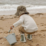 Scrunch bucket, sage green, lifestyle shot child at beach