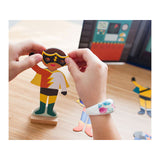 Superheroes - Magnetic Costume Builder, child's hands playing with figure in mask