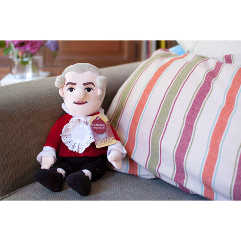 Mozart - Little Thinker Doll With Musical Box, lifestyle shop sitting on sofa with striped cushion