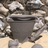Scrunch bucket and spade mushroom , beach scene with moulds in foreground