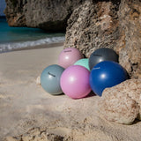 Scrunch Ball - Old Rose, with other colour balls on beach 