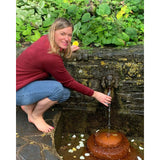 The moon child author Laura Cowan in garden by tap