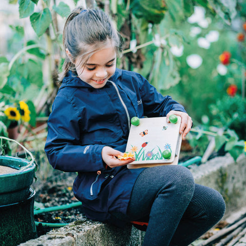 Flower Press, girl displaying in garden