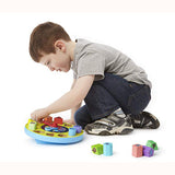 Chunky Shape Sorting Clock, with child removing some pieces 