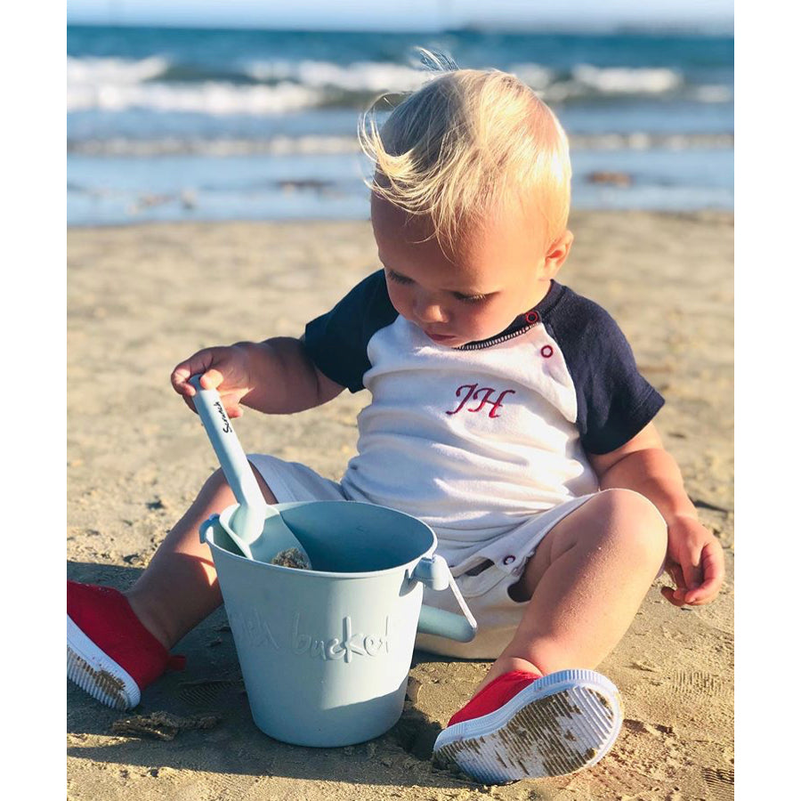 Scrunch Bucket & Spade Set - Duck Egg Blue, child sitting on sand playing