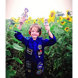 Boy holding Flynn lottie doll and astronaut doll