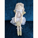 Grace Wilberry Doll sitting on teal chair