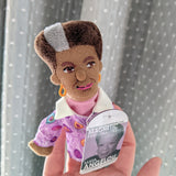 Maya Angelou Finger Puppet, posed on hand