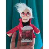 Andy Warhol Finger Puppet , green background, posed on hand