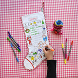 Colour -in Christmas Stocking, child's hand and arm visible, pens, christmas list side