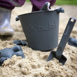 Scrunch Bucket & Spade Set - French Navy, on beach with wellies behind