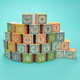 Classic ABC 28 Blocks With Canvas Bag, blocks unboxed in a curved wall