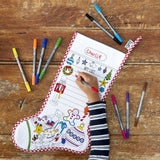 Colour -in Christmas Stocking, on wooden floor, being completed by child's arm