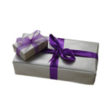 Classic silver wrapping paper gifts with purple ribbon