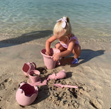 Scrunch Panner (Beach Sieve) - Dusty Rose, child playing on beach with other items in range visible