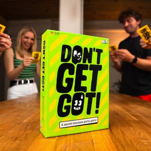 Don't Get Got! - A Secret Mission Party Game, boxed game surrounded by players