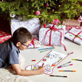 Colour -in Christmas Stocking, boy colouring in on floor with pens visible, by tree