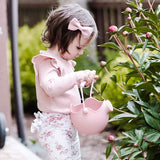 Scrunch Watering Can - lifestyle child watering peonies